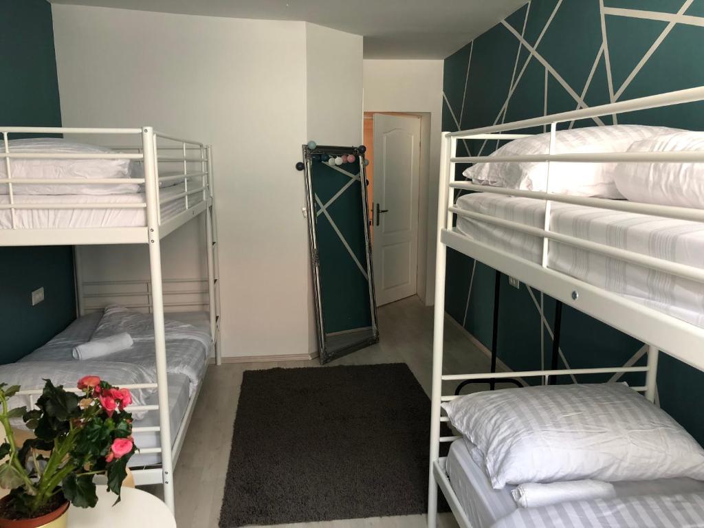 a room with three bunk beds and a hallway at Hostel Sleeping Beauty in Ljubljana