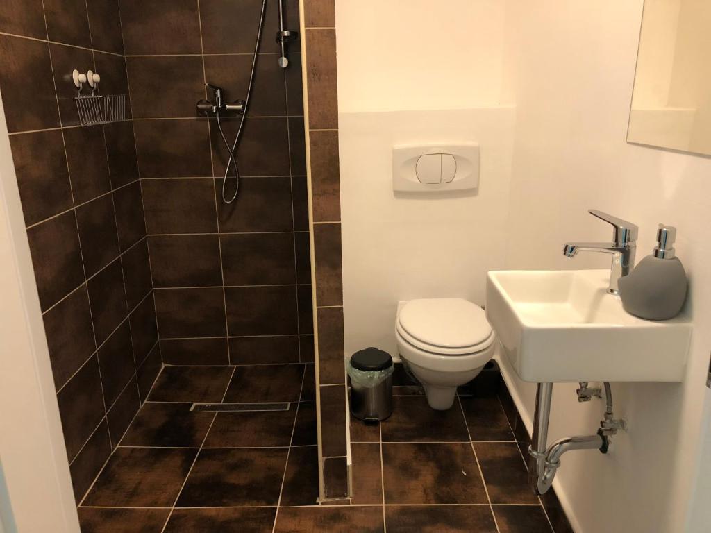 a bathroom with a shower and a toilet and a sink at Hostel Sleeping Beauty in Ljubljana