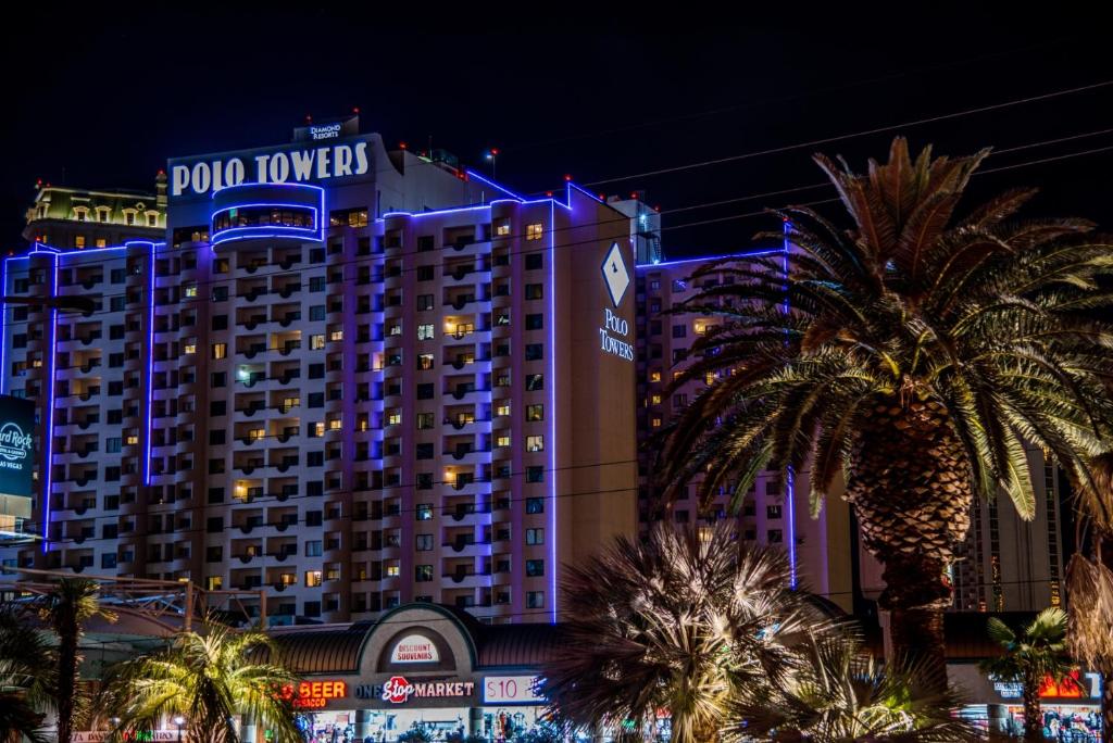 a large building with blue lights on it at Polo Towers by Raintree in Las Vegas