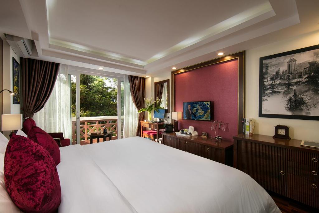 Postel nebo postele na pokoji v ubytování Sapa Horizon Hotel