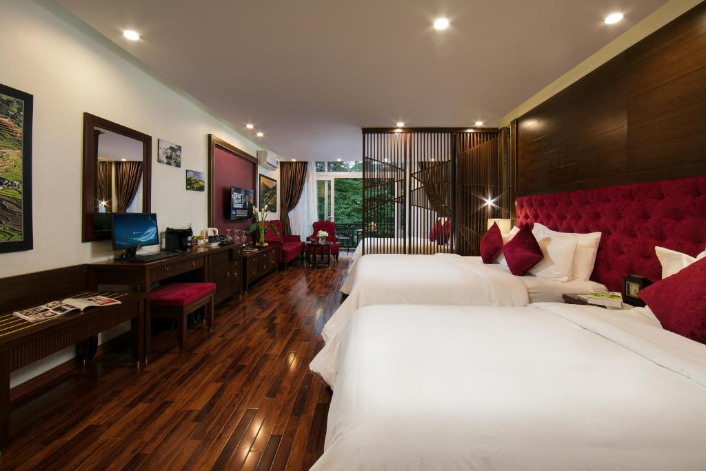 Postel nebo postele na pokoji v ubytování Sapa Horizon Hotel