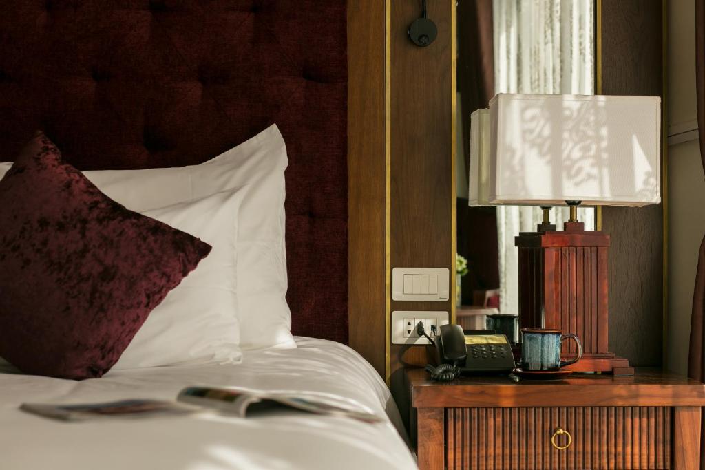 Postel nebo postele na pokoji v ubytování Sapa Horizon Hotel