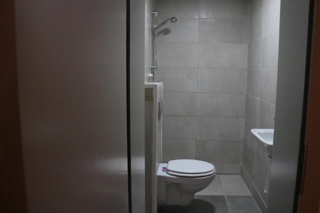 a bathroom with a toilet and a sink at Hostel Sleeping Beauty in Ljubljana