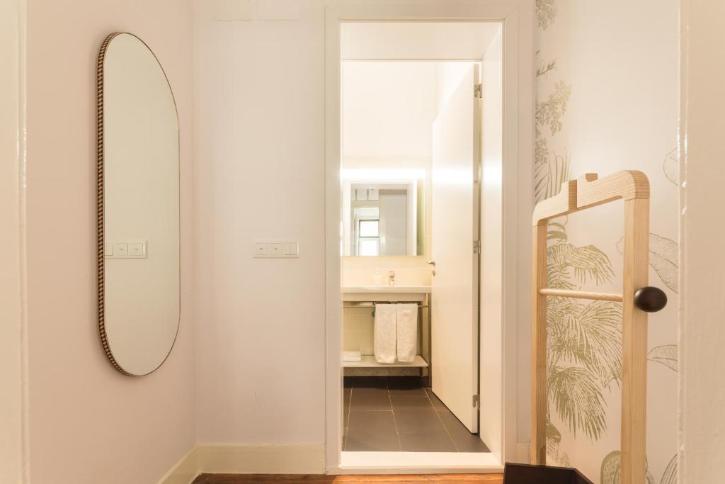 a bathroom with a mirror and a walk in closet at The Visionaire Apartments in Lisbon