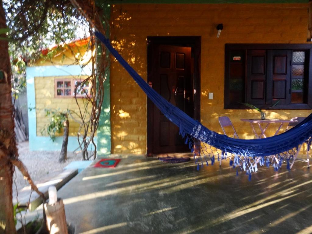 a hammock in front of a house at Chalé Chapada dos Veadeiros in Cavalcante