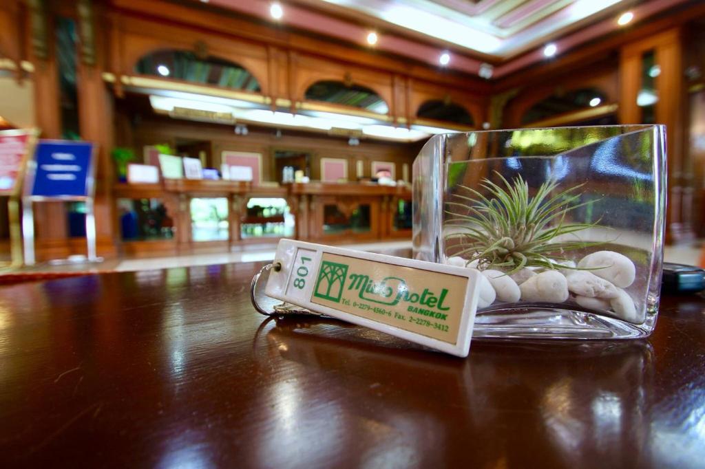 A small air plant centerpiece on the polished reception desk.