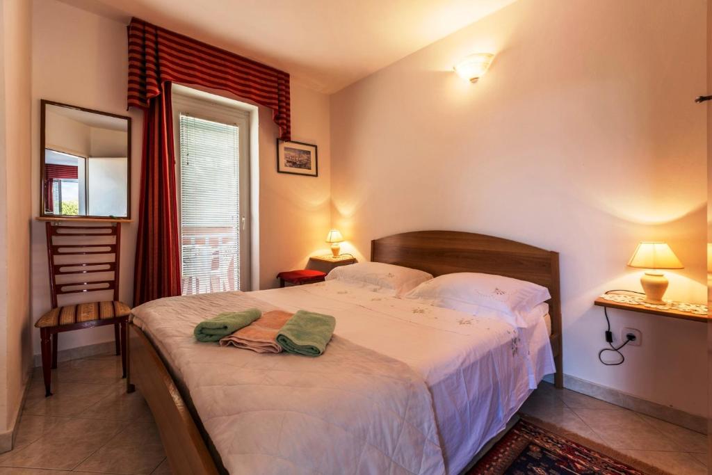Posteľ alebo postele v izbe v ubytovaní Appartment Daniela Funtana