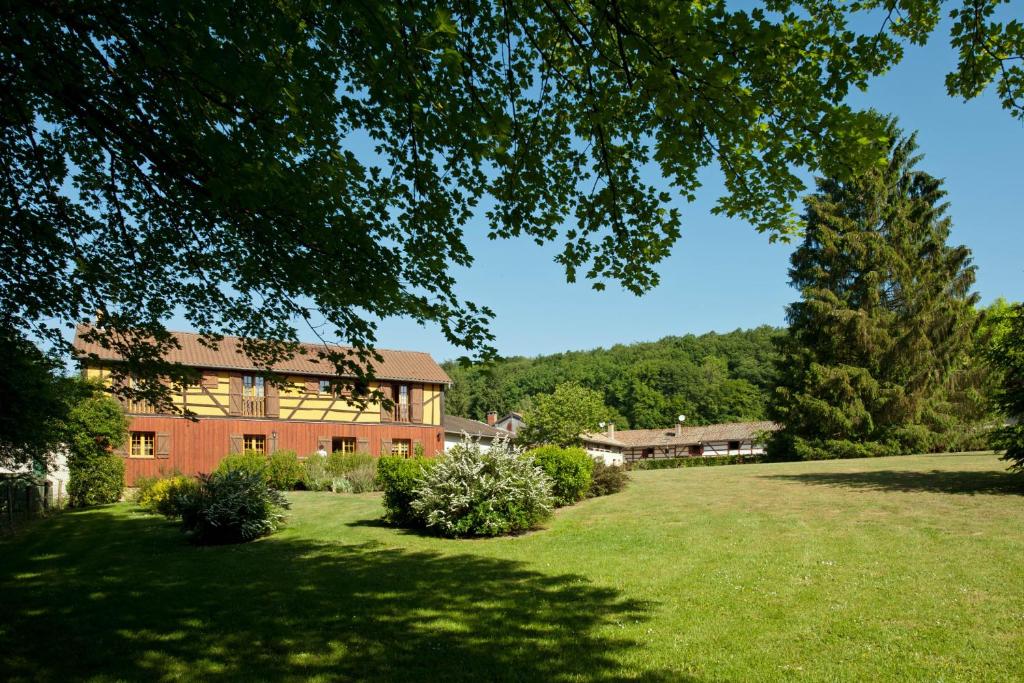 a large red brick house with a large yard at le four au bois in Futeau