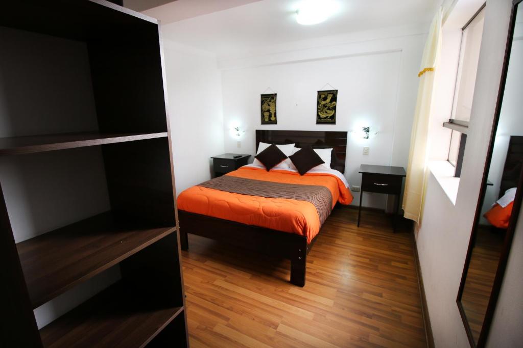 Postel nebo postele na pokoji v ubytování Hotel Peru Real