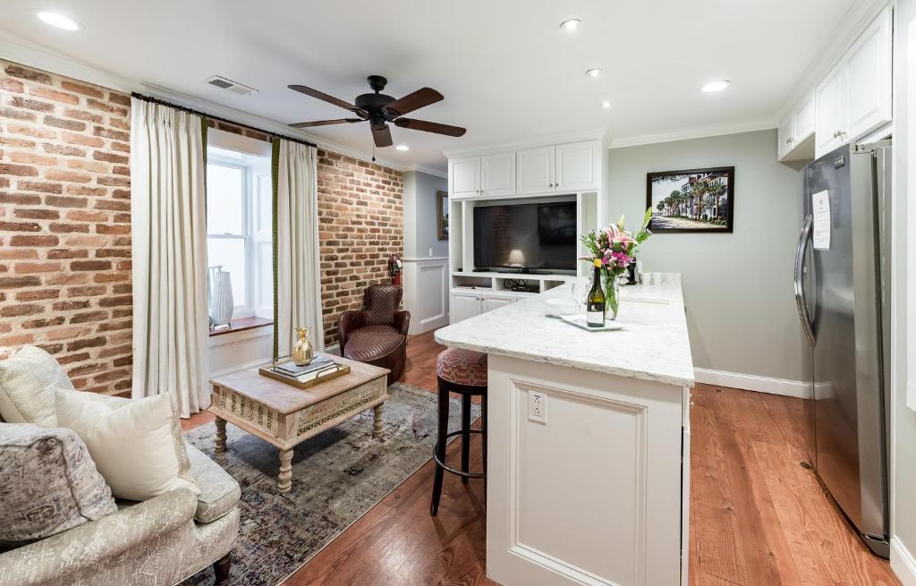 a kitchen and living room with a brick wall at The Quarters on Vendue in Charleston