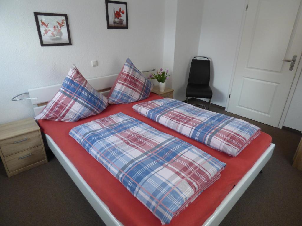 a bedroom with a bed with two pillows on it at Ferienhaus Tamm-Voß in Grömitz