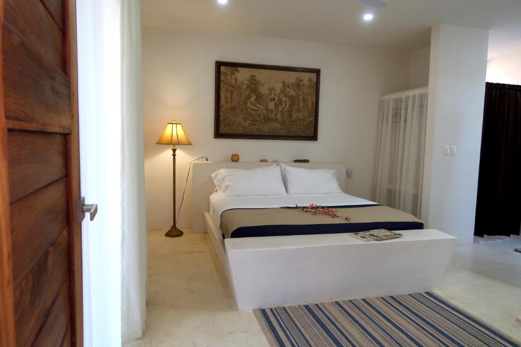Postel nebo postele na pokoji v ubytování Hotel Casa de Campo Conkal Merida