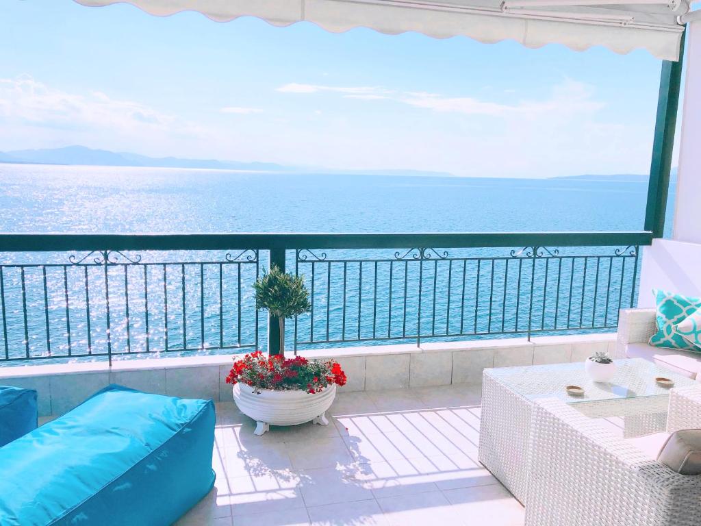 a balcony with a large view of the ocean at Colours Seaview Apartment in Néa Artáki
