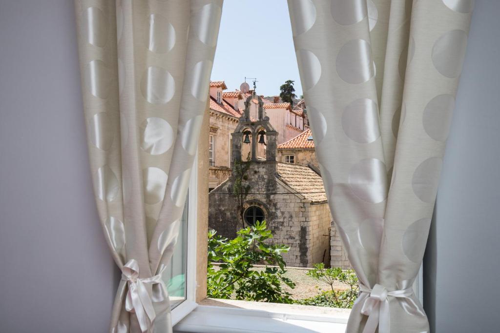 an open window with a view of a church at City Center Rooms in Dubrovnik