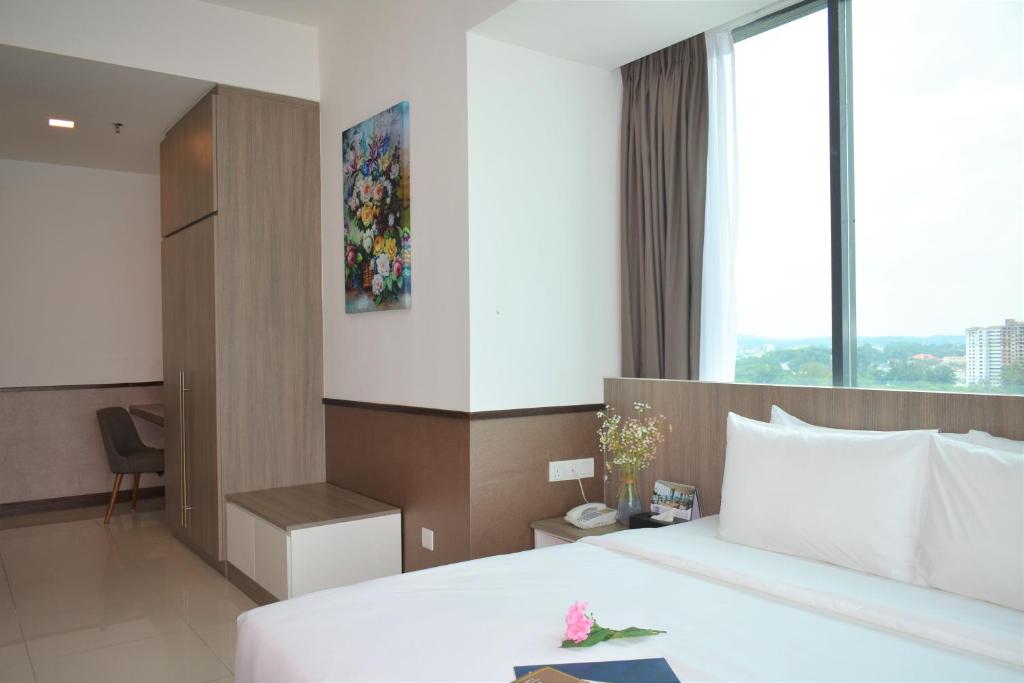 Postel nebo postele na pokoji v ubytování D'Wharf Hotel & Serviced Residence