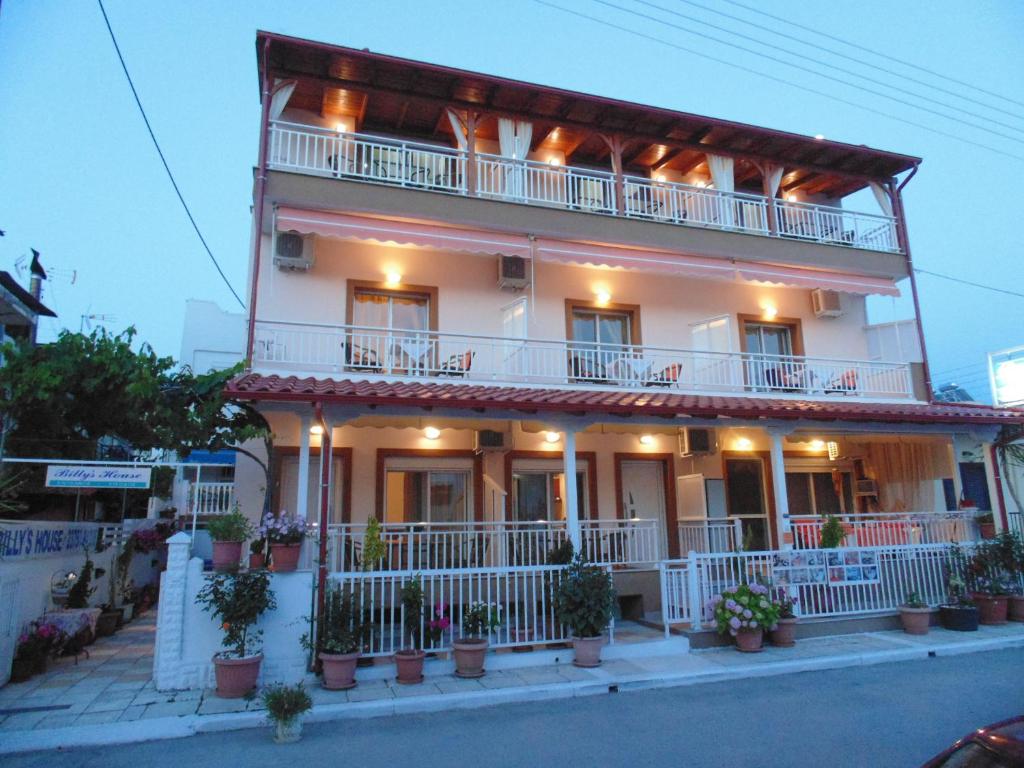 a large white building with a balcony on a street at Billy's House in Sarti