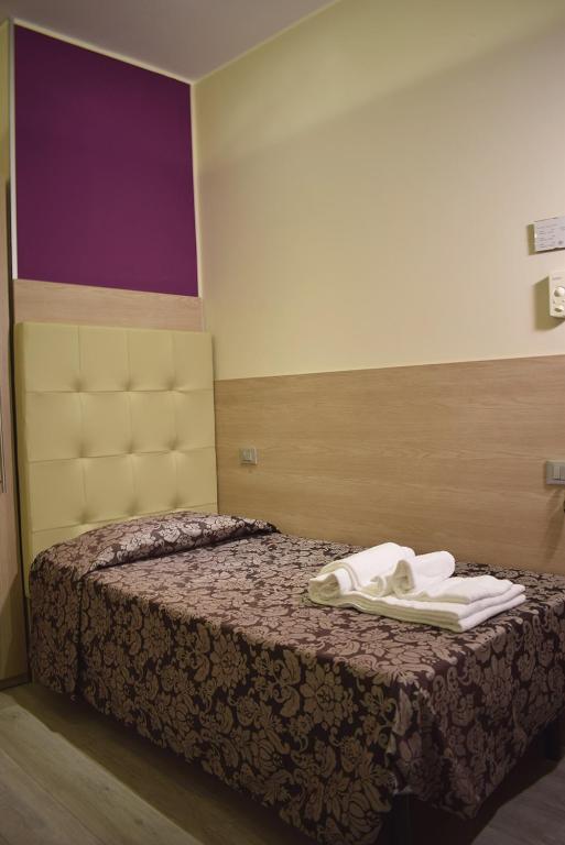 a hotel room with a bed with towels on it at Hotel Baffo Rosso in Alba Adriatica