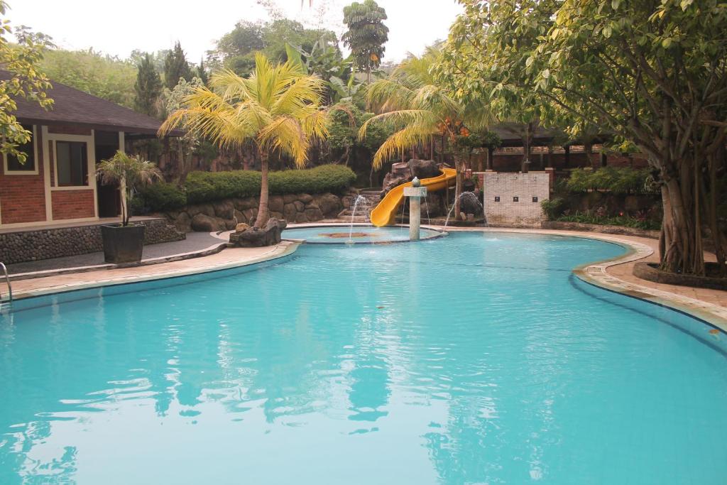 een zwembad met glijbaan in een resort bij New Green Sentul Resort in Bogor