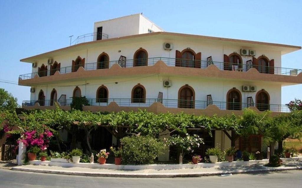 a large white building with plants in front of it at Lefka in Kolymvari