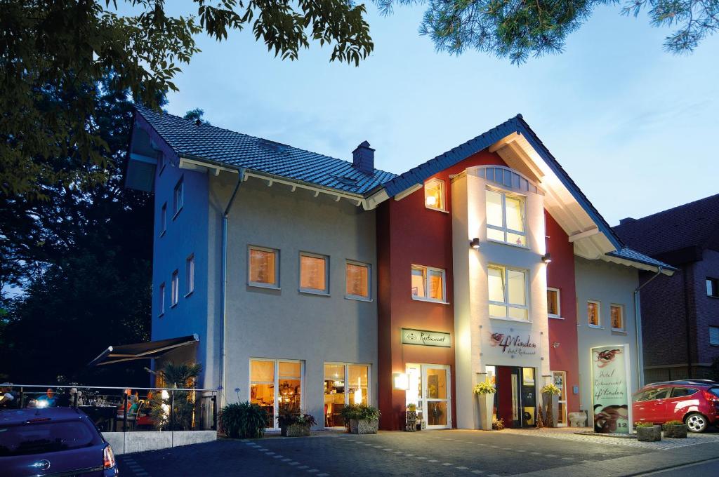 ein Gebäude mit einem davor geparkt in der Unterkunft Hotel & Restaurant 4 Winden in Windhagen