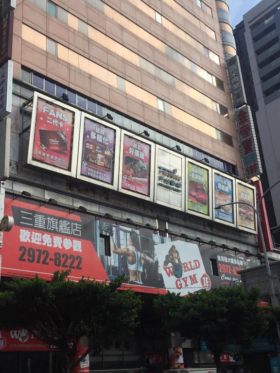 a building with lots of signs on the side of it at Wemeet Hotel Taipei in Taipei
