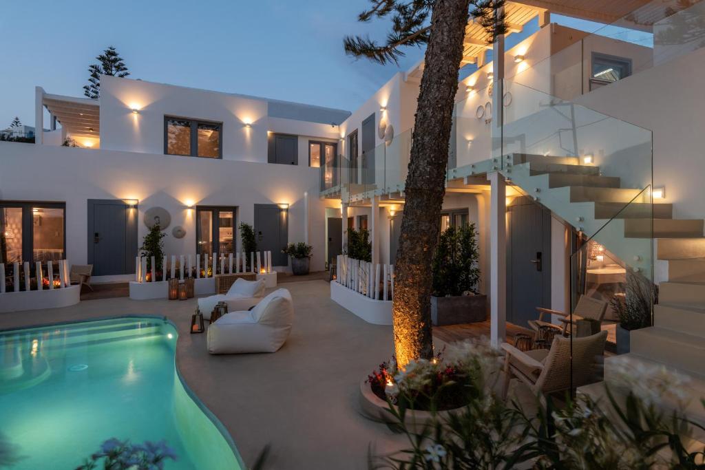 a villa with a swimming pool at night at Oniro Suites in Mikonos