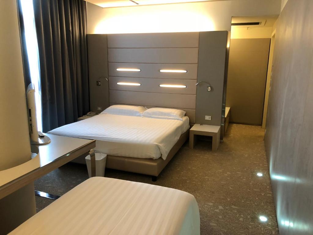 Krevet ili kreveti u jedinici u okviru objekta Best Western Plus Net Tower Hotel Padova