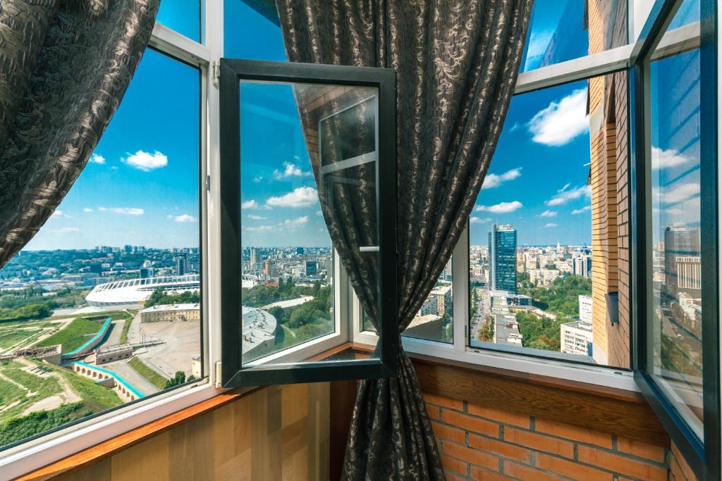 a window with a view of the city at New building near Arena City Lesi Ukrainky 7a in Kyiv