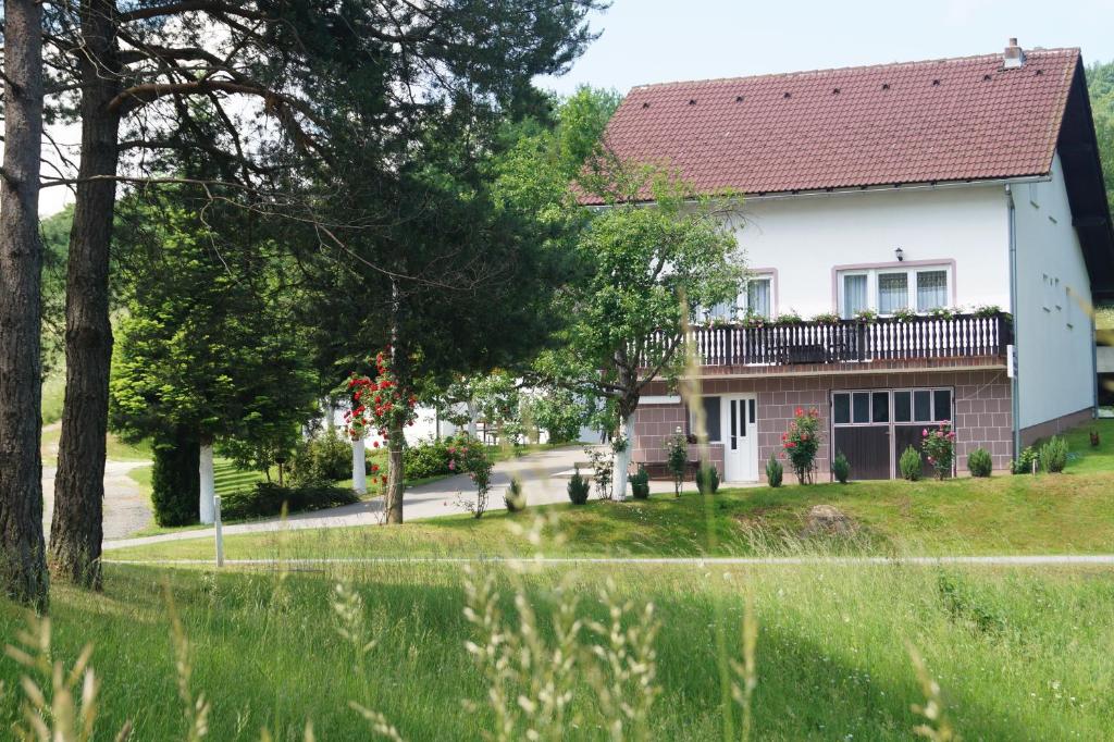 a white house with a red roof at Apartment Drago in Rakovica