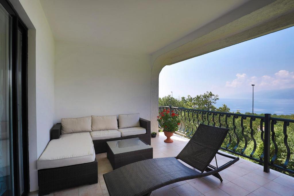 a living room with a couch and a chair on a balcony at Vrata Jadrana in Rijeka