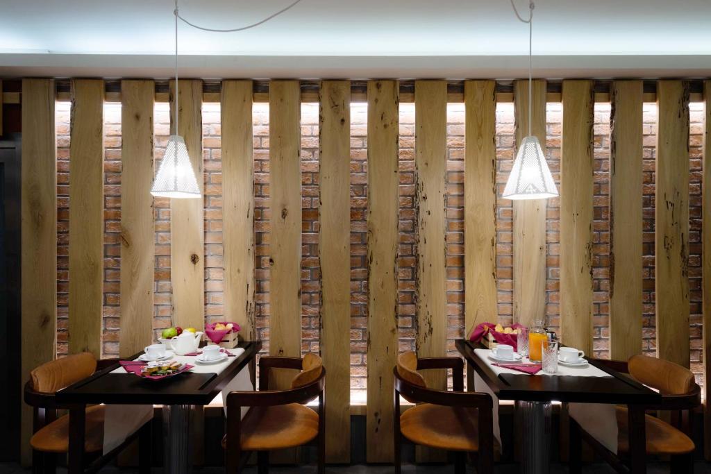 two tables in a restaurant with wooden walls at Hotel Paganelli in Venice