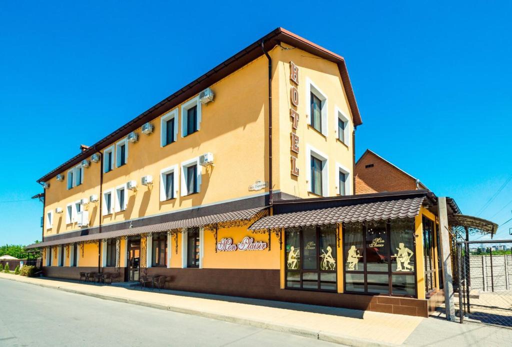 a building on a street with a store at Mon Plaisir in Vinnytsya