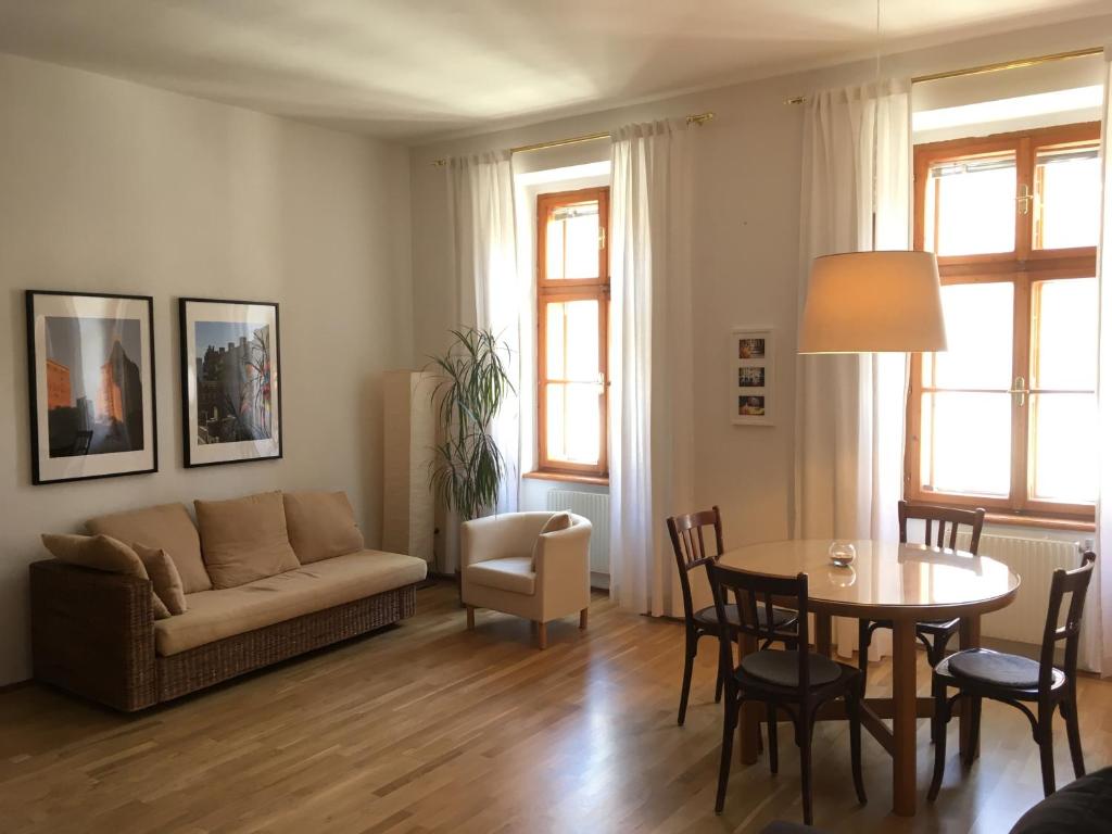 a living room with a couch and a table at Apartments near Rathaus in Vienna