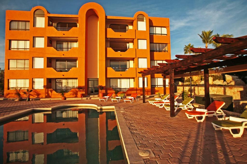 a large building with a lot of windows at Sunrock Condo Hotel in Cabo San Lucas