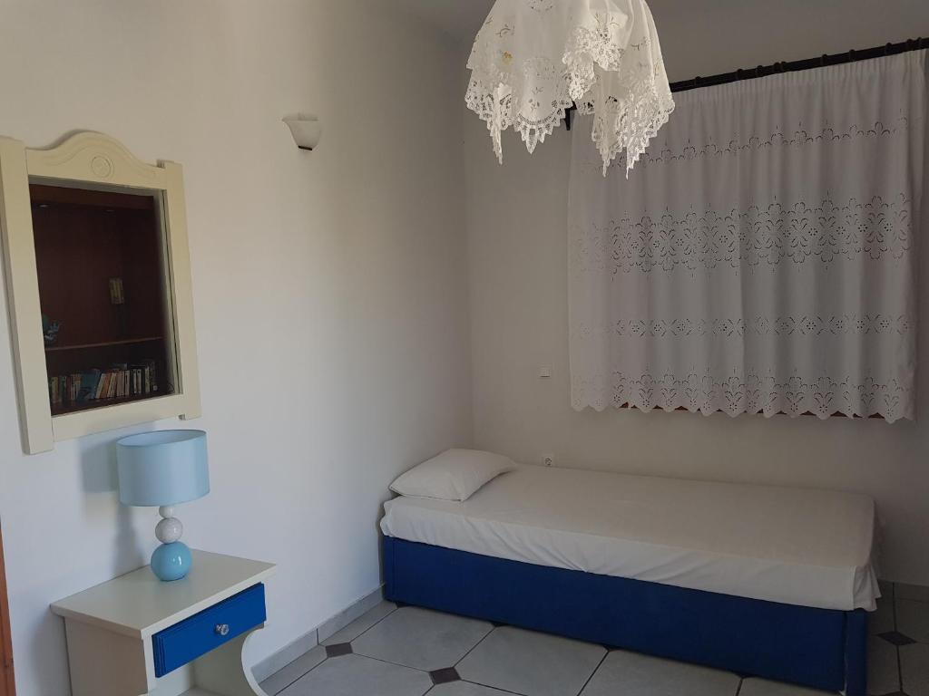 Postel nebo postele na pokoji v ubytování Ragoussis House