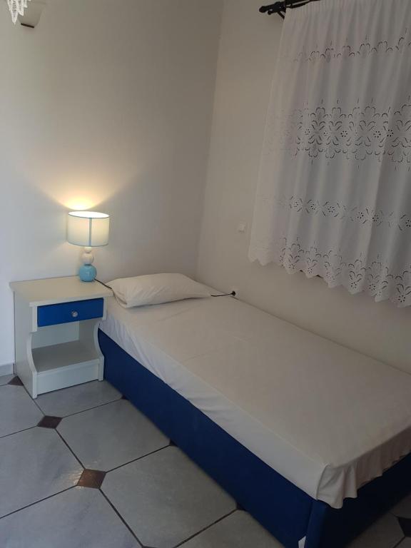 Postel nebo postele na pokoji v ubytování Ragoussis House