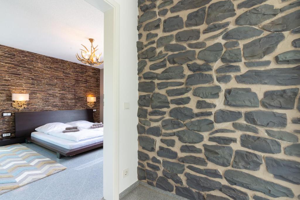 a bedroom with a stone wall at HöriLux in Gaienhofen
