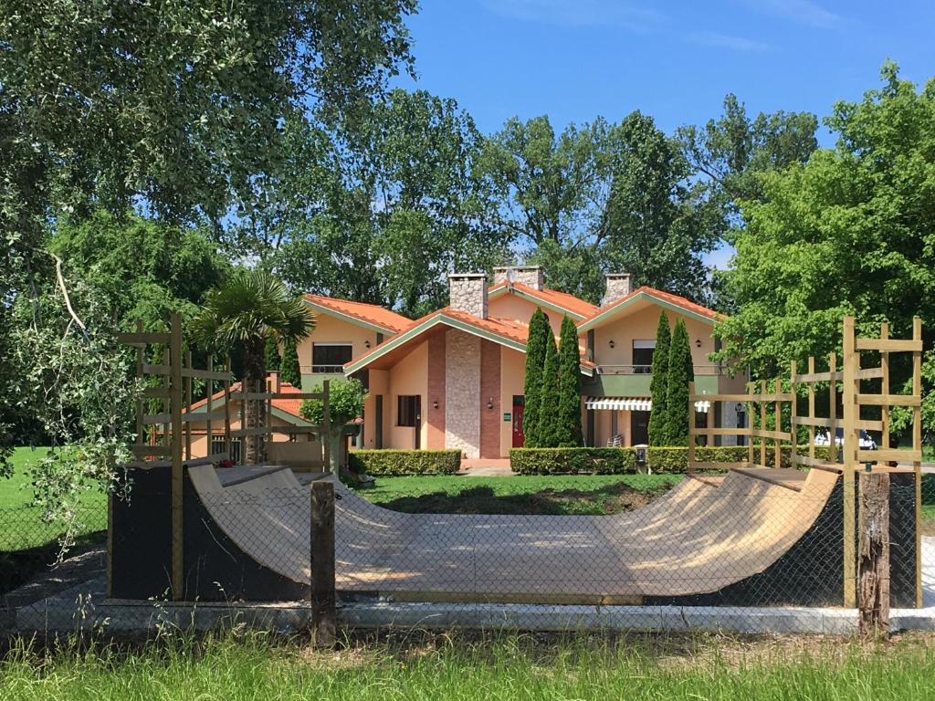 a house with a fence and a slide in front of it at Somo Surfskate hostel in Castanedo