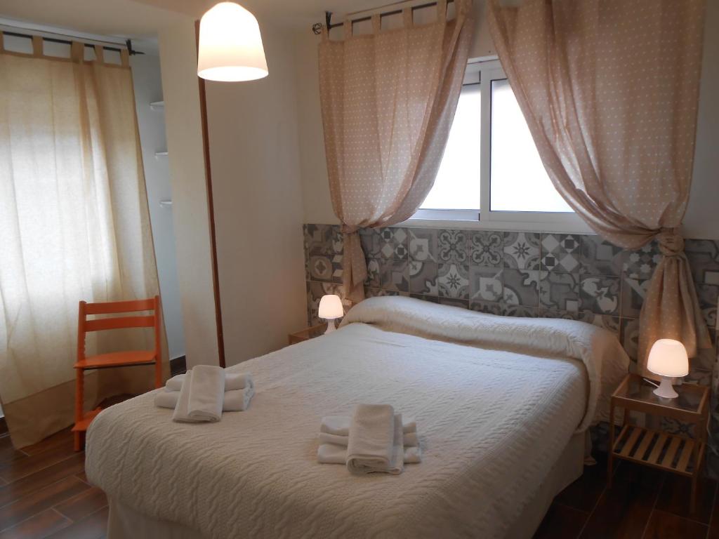 1 dormitorio con 1 cama con 2 toallas en Apartamento Centro Abad, en Granada