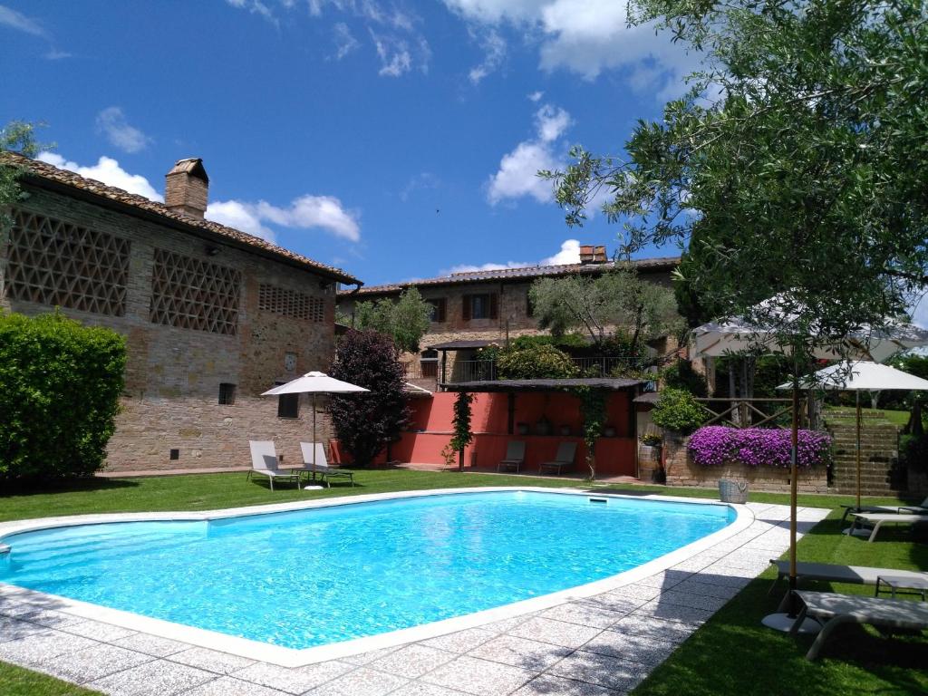 a swimming pool in the yard of a house at Villa San Michele in Barberino di Val dʼElsa