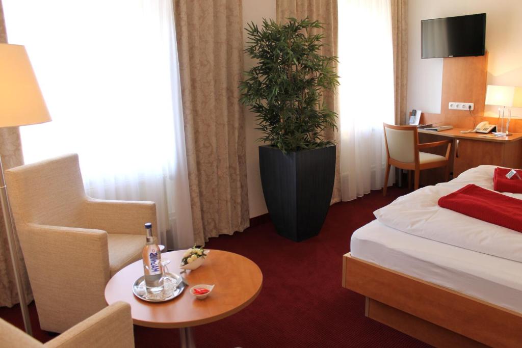 Postel nebo postele na pokoji v ubytování Hotel Ostseeresidenz Cammann Grömitz