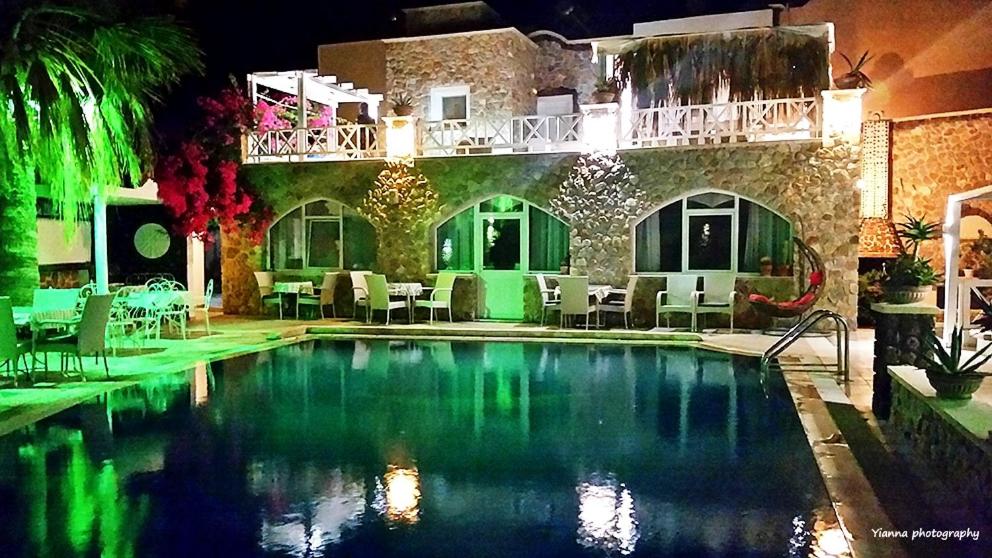 a swimming pool in front of a house at Atalos Suites in Kamari
