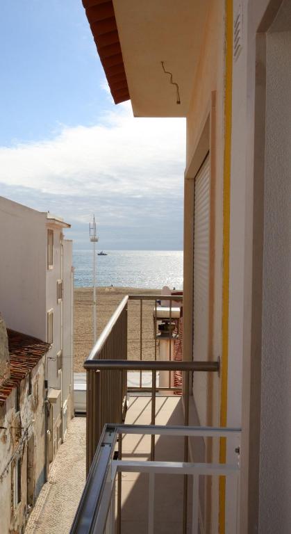 a balcony with a view of the beach at FerhouseDreams-Praia in Nazaré