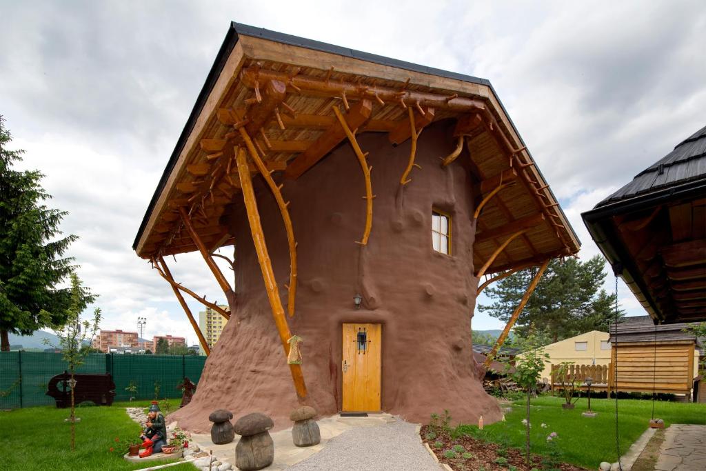 a house shaped like a tree with a yellow door at Rozprávková dedinka in Dolný Kubín