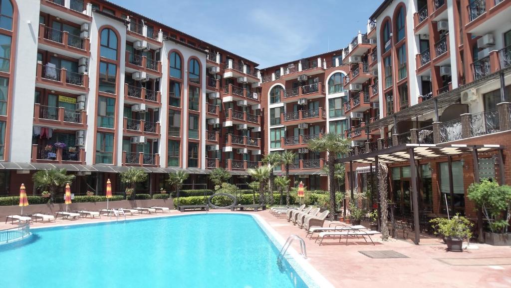 a swimming pool in front of some apartment buildings at Chateau del Marina Apart Complex in Nesebar