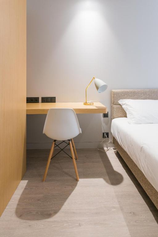 Un ou plusieurs lits dans un hébergement de l'établissement BessaApartments