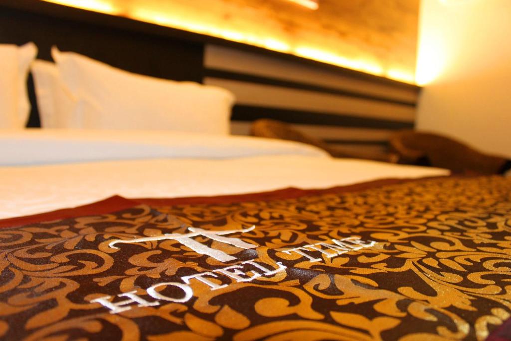 Postel nebo postele na pokoji v ubytování Hotel Time Boutique Nilai