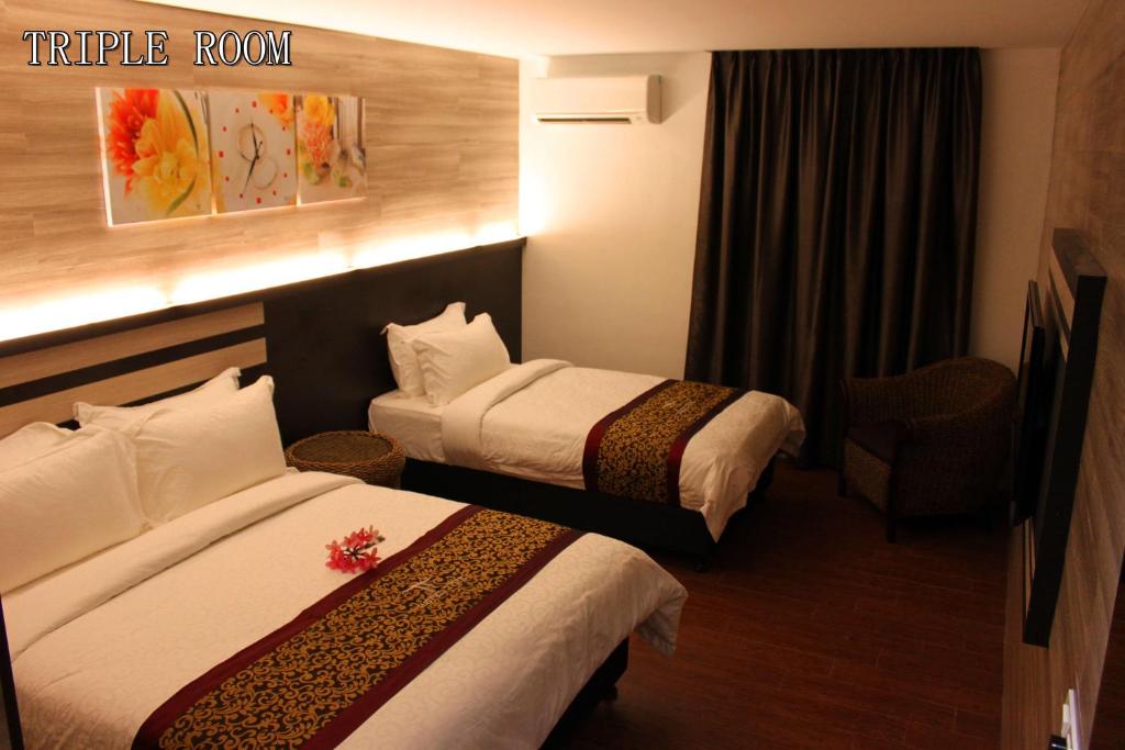Postel nebo postele na pokoji v ubytování Hotel Time Boutique Nilai