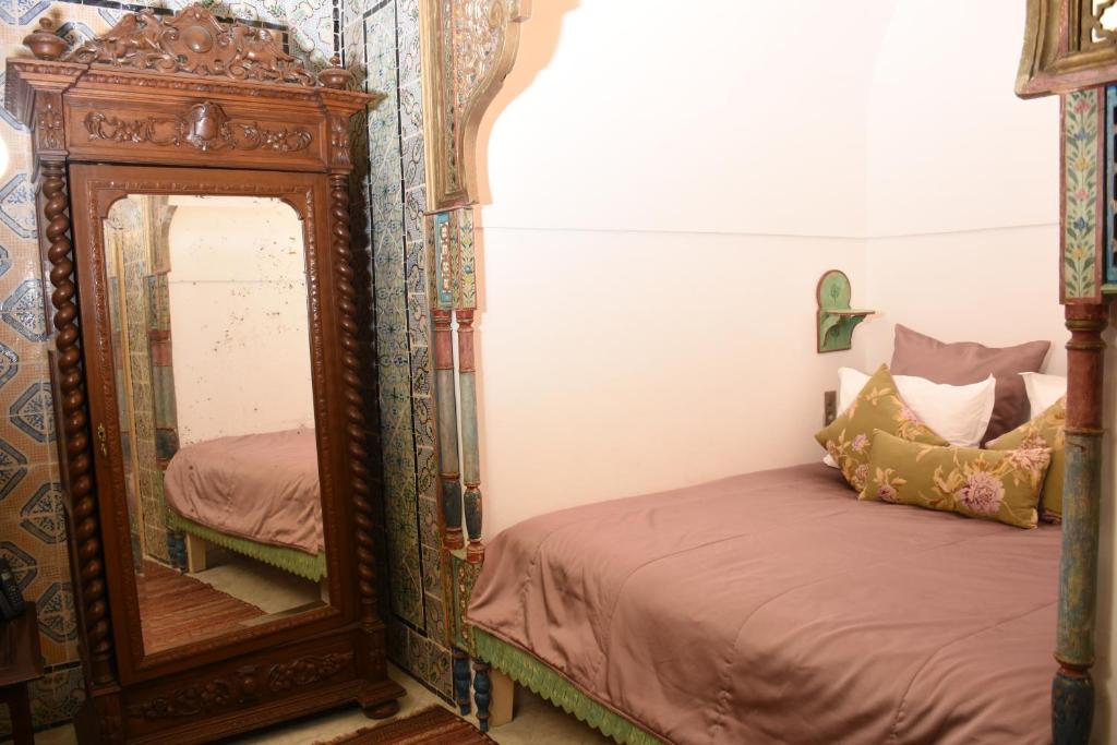 a bedroom with a mirror next to a bed at Palais Bayram in Tunis
