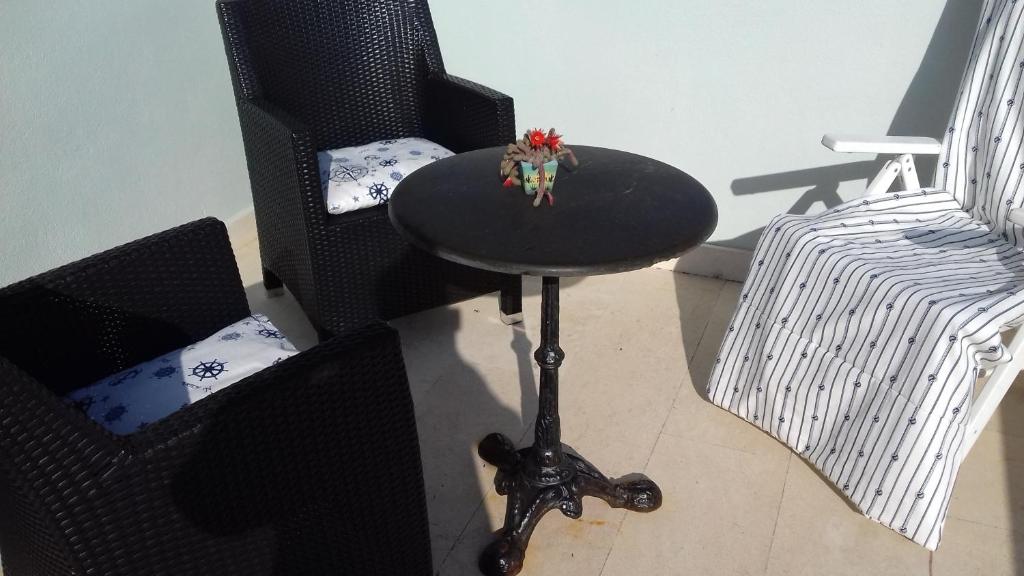 a table and two chairs and a stool with a toy on it at Apartman Lavanda in Sutivan